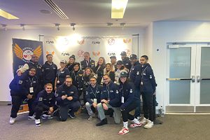 Students in navy District 9 jackets pose for a group photo.