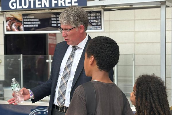 A District 9 leader talks with students at the Back-to-School Resource Fair at Yankee Stadium.