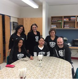 District 9 staff members in matching shirts around a table