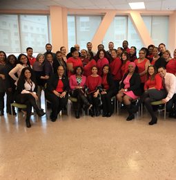 A large group of District 9 staff dressed in red and black