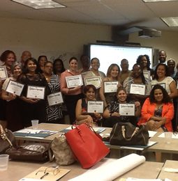 Educators holding certificates at a professional learning session
