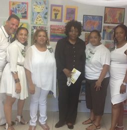 District 9 staff dressed in white at a school celebration