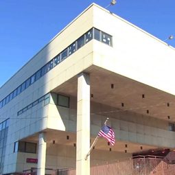 A modern District 9 school building with an American flag